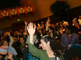 Audience raising hands to indicate where they're from
