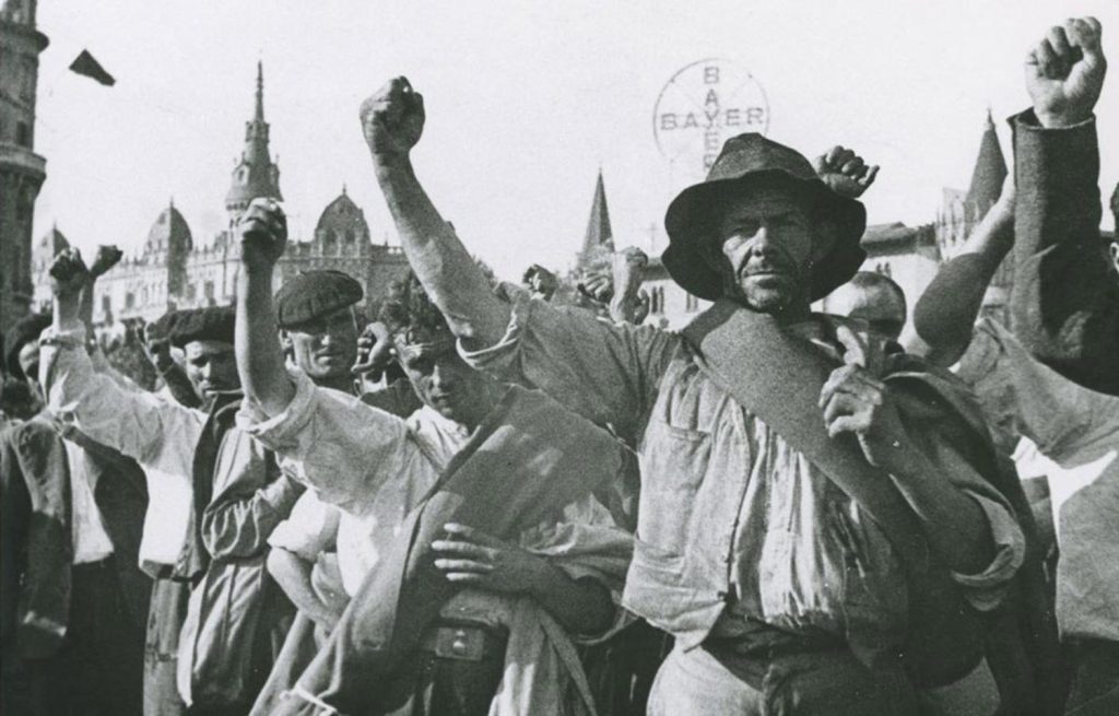 Peasants from Extremadura, saluting with their fists, after carrying out the occupations of farms in March 1936. Photo: David Seymur.