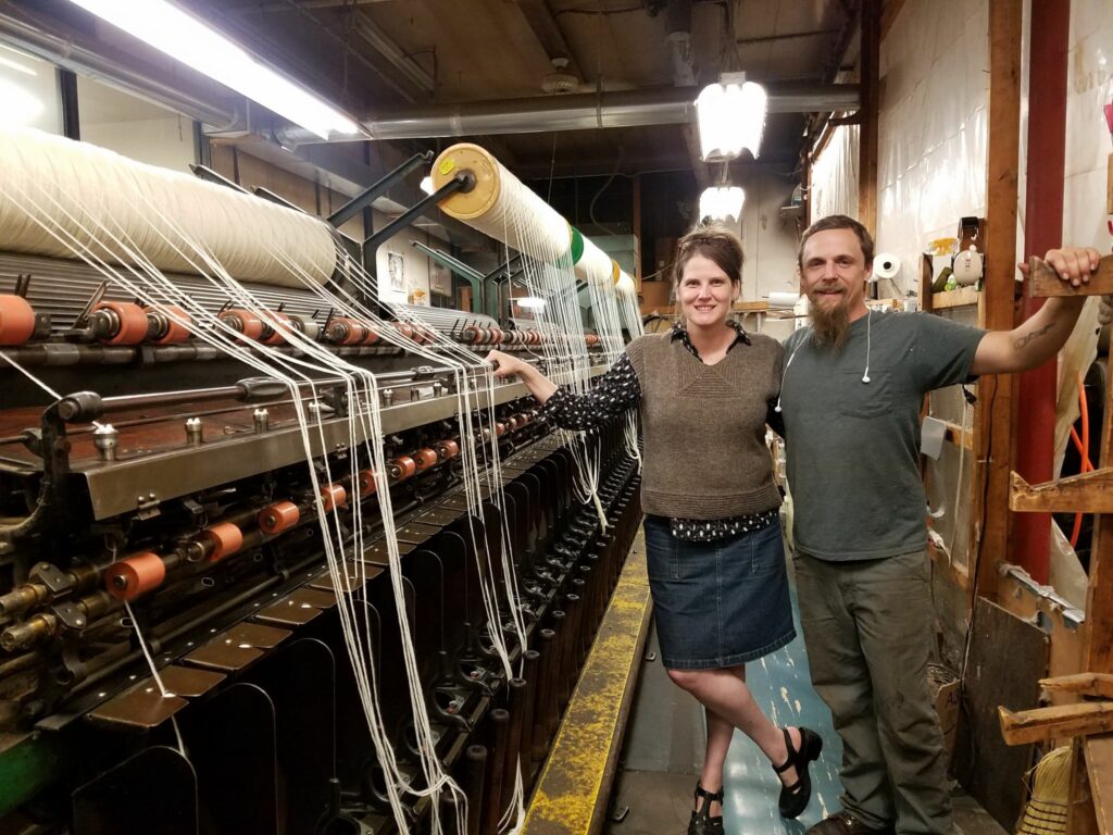 Worker-owners of Green Mountain Spinnery Co-op in Putney, VT show off the spinning equipment that makes their natural-fiber yarn.