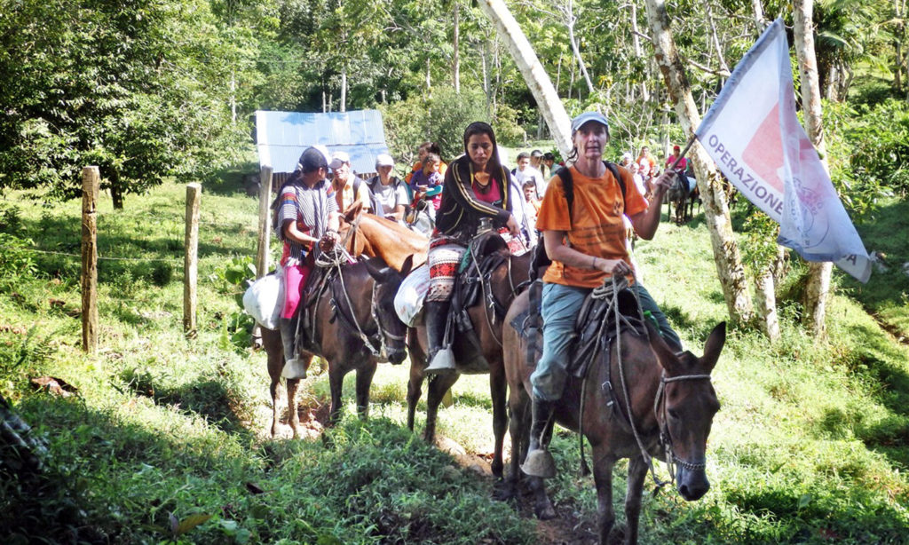 Volunteers of the nonprofit organization Operazione Colomba accompanying some members of the Peace Community to Mulatos village.