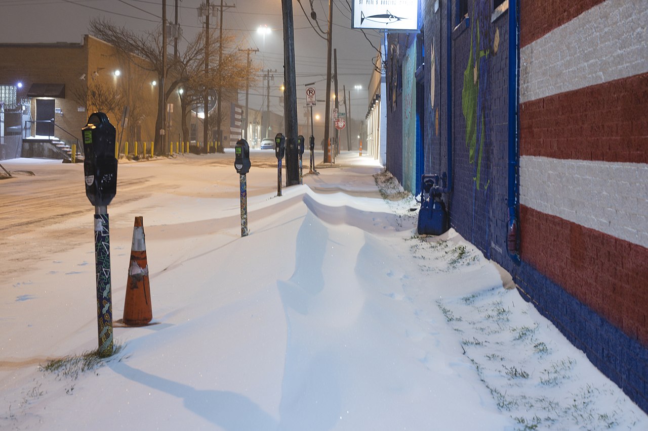 Sidwalk covered in snow in Dallas, TX, following the February, 2021 winter storm.