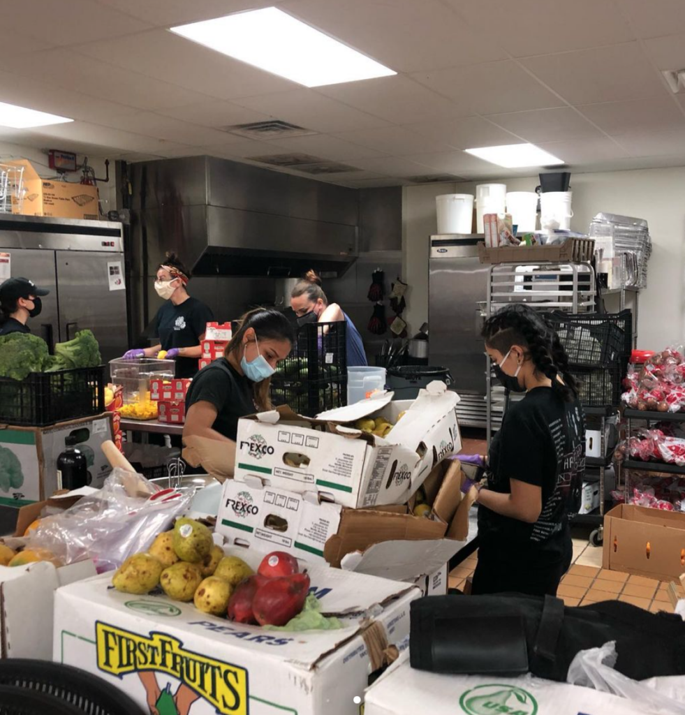 The crew of Project La Familia prep meals for distribution.