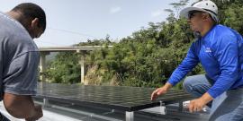  Members of environmental nonprofit Casa Pueblo install solar panels in Puerto Rico’s Adjuntas community. Photo by Arturo Massol.