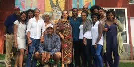 Members of the National Black Food and Justice Alliance in front of a mural.