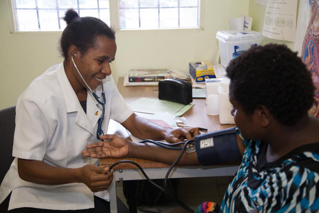 Doctor performs blood pressure check on a patient.